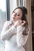 This dress was perfect. Everything that I wanted in a gown. I ordered a large in the dress but then lost some weight. I had to have it taken in quite a bit. A medium would still have had to be altered, but it would have fit better. - Candida S.