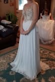 This dress to the most flattering dress I have tried on throughout this entire process.  It falls nicely in all the right places.  The bead work is amazing and beautiful.  The quality of this dress is even better than similar versions I tried on in bridal shops, at much higher price tags.  This dress was not the style I was going for for my snowy, wintery wedding but am so very tempted to shift my idea.  It fit like a glove.  I was torn between a size 6 or 8, and decided to go with the 6.  It fit perfect. Is comfortable to move and sit in as well.  Do not hesitate if you are considering this dress. - Sarah D.