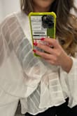 This is definitely a style I would buy. I love the cut and how flowy it is, however the fabric is very see through and it is awkwardly lined in the middle. It isn't as see through in the photos as it is in person which is very misleading so I'm kind of disappointed. It's still cute if you were to use it as a cover up but I wouldn't wear this out with jeans like the other model did. Would have to return. - Chi N.