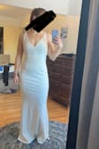 I ordered this dress in black, and let me tell you, it's a stunner. Loved it. The material felt thick (not cheap) and the M fit me like a glove. So I thought I'd also try it in white to see if it could be a wedding dress contender. Unfortunately, the white fabric revealed that it is a cheaper-made piece and for some reason just didn't look like as good of a fit in the same size. I still think the shape is gorgeous, but personally I'd buy this one in other colors over the white. - Jenny W.