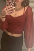 Love it. Good quality & stretchy material. I love the color and the vibe. Shows a little midriff. Shoulders fall off a bit. - LeClare B.