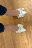 I have been looking for heels with bows (similar to the J.Crew satin mules or Kate Spade ones) for my rehearsal dinner. I was pleasantly surprised by these shoes! The toe area is a little stiff but I have wide feet so pointed toes are never comfortable anyway. The color is ivory but the hue is slightly more blue than yellow if you are looking for a particular shade. - Caroline P.