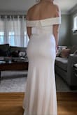 I ordered this for my small wedding ceremony so I could save my actual dress for our big wedding. I ordered both a large and a medium to see what fit best. The medium was a little tight in my chest/stomach so I went with the large just so I felt more comfortable. It is SUCH a flattering fit and the material is really nice and elegant.  The neckline is stunning! - Katie M.