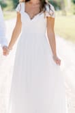 This dress was perfect for my COVID minimony! We got married with only our parents and grandparents and the dress was just dressy enough to be the bride but not overwhelmingly fancy or anything! I tacked the open shoulder sleeves up for personal preference but it was gorgeous with the sleeves down as well! I am 5'4" and the XS fit me in length well with my short heels! - Samantha C.