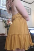 I love the color of this dress. Perfect for a summer day or night. My only issue is that the back folds over a bit, but that's typical for halters when you have DDs I suppose. Arrived as described. Decent quality. Much love for this sunny sexy dress. - Ellen W.