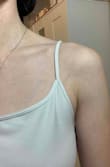 This used to be my absolute favorite tank top! (The version I bought a couple months ago still is) I wear it constantly as you can tell from how it's no longer white lol. The new one is different in every way. I wish I could add more photos because it's actually laughable that these are both the xs/s. Lined up side to side the new one is over an inch smaller than my first one. I also wash my clothes on cold and air dry everything so there is literally no way laundry could have caused my original one to somehow stretch out. Im super sad cause people actually make fun of how much I wear this tank although the large is too big. Oh well! - Grace K.
