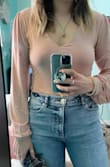 I bought this in a large, typically have to with bodysuits cuz they never seem long enough for my torso but part of me wishes I had tried the medium. Sleeves are a tad long but that's better than too short! They still feel like they fit really nicely despite being a bit large - I have the blush and the burgundy and love them both! - Stephanie C.