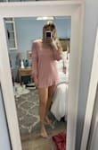 I prob could've sized up, however the way it fit on me, was horrible. The sleeves were kinda cute, but the body didn't flatter me in any way. If I bent down to grab something it would've been game over, everything would've been shown. The material is eh, nothing fancy - Kara W.