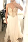 Beautiful dress but didn't look quite right on me. The model is tall with a small torso. The tie in the back makes the sizing more flexible. I was wearing a size 4 in this picture. Dress was very long. - Christine W.