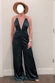 First time buying a Lulus jumpsuit and had to guess on size. I fit in S dresses, but with athletic legs I love my M Lulus romper. For this one I would consider down a size. There was a lot of extra fabric around the middle and legs (more than what the style looks like per the model). I loved the back and plunge neckline. I also loved the satin feel and drape, but would be worried about snagging it. I also would have to hem it, unless the S is also shorter in length. My tallest pair of heels and the legs were still dragging. Tried on with the Ivory Straw Bucket Hat. - Andie F.