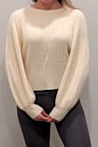 The shorter torso shows off a nice pair of high waisted jeans for a cold night out, but then I come home and switch to yoga pants and its still the perfect sweater. It is not white, definitely more of a cream color. The sleeves are a good length past the wrist, but if you do not like short sweaters, I would not recommend. - Andie F.