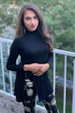 Fits comfortable. Great black classic top with a unique cut. - Maheen S.