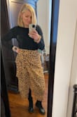 I wore this with tights and doc martens when it's cold, and plan to wear it with sandals and a crop tank or body suit when it's warm! It does take some arranging to make sure the slit from the wrap won't reveal all the way to your waist when you sit down, but that's okay. It is super cute and forgiving around the waist and hips. - Bailey U.