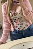 I love the color and style, but it runs large and the sleeves stretch at least an inch past the tip of my fingers. I purposely shrunk it in the dryer and it helped a bit, but the sleeve length does bother me. If I would've ordered a small instead of a medium, I assume it would've been perfect - Olivia A.