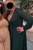 I chose to wear this dress for my daughters baby shower and received several compliments. Because it is a wrap dress, it is very forgiving for size adjustments. However, like a lot of other comments it is super low cut. As you can see in my photos, I have a gold sequin cami under mine. So plan for that. Other than that the dress is beautiful, and flows well. I like how the sleeves are sheer, but the rest of the dress is lined. The dress can be dressed up or down and worn for several occasions, I plan on wearing it again!! Give it a shot! - Kellie B.