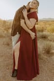 Bought this for our engagement photoshoot and I loved it! The color was perfect, and the style with the leg slit was gorgeous. It did run a little big on me and was a little long as well, even with heels on. But other than that I would definitely recommend buying this dress! - Kristin K.
