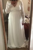 This dress fits quite well, and the material is more comfortable than I had anticipated! Being on the shorter end, I was surprised how well the length works for me; while it's a little long, it's significantly shorter than the other wedding dress I ordered from Lulus. The lace on the arms is a bit baggier than I had hoped, and I would consider my arms to be slightly bigger than average, so I am going to see if my seamstress can do anything about that. I also plan on having the band around my mid-back let out a little, as it's just a tad too tight and I want to be super comfortable! Also, I'm pleasantly shocked that I will not have to wear a bra with this. :) - Jenae C.