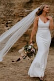 We eloped so I wanted something simple. I was right in between and medium and large so I sized up but did take it in to a seamstress to have the waist taken in a bit more and had her add a slit! Overall loved how it turned out and it was extremely comfortable to be in. The material isn't to thin but not to thick. Easy enough for us to do a mini hike to get some pictures! - Kylie F.