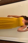 I want to love this dress but I don't think I do. The bottom is a little heavy and a lot of material. Your leg doesn't show unless you move the material or hold the dress open while you walk. For me personally, it's a little unflattering on the sides by my arm pit area. You know, that awkward roll thing that is there unless you have perfect side boob. I want to wear it to my friends wedding but it doesn't look that good on. - Lisa T.