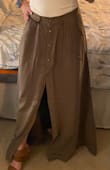 I did end up getting this skirt hemmed because it was too long for me but it's still super cute. It's a thicker material so probably wouldn't wear it if it's going to be too hot out but I love that you can adjust the snaps to be more open and show more leg. - Tara M.