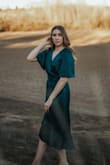 I got this dress in the green for my graduation pics. It is so flattering and it's a beautiful color. The material is nice bc it doesn't require ironing.Only thing I struggled with was the bust fit me a little weird and would often show my bra, but I'll probably just sew it a little bit. - Jennifer P.
