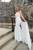 I purchased this dress last minute for my wedding and I am SO glad I did. I ordered a 6 (my usual size) and a size 8 just in case. I ended up wearing and keeping the size 8 and will send back the size 6. My hips are 39" and while I could "fit" in the size 6, I could barely walk because of the mermaid style. This dress is truly a beautiful gown and has such beautiful details and lace on the outer layers. The bust would fit many sizes. One suggestion is don't tie the strings too tight across your back because they will dig into your skin in pictures and not be too flattering. Lol, but I am in love with this dress and the train is beautiful. It is very long, but I wore 4.5" heels and it worked well for me. I picked up the bottom while I walked around and it was perfect. - Lisa F.