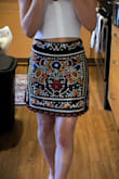 When it arrived, I was wary of the material, as it looked bulky, and since I'm 4'11" petite, I was nervous it would be big. I tried it on and it fit really well around the waist! The skirt itself is not as mini as the picture, but that's because I'm small. I'm keeping it, as it would look so cute in the summer with some sandals or heels! - Meli S.