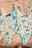 I get it, its tie-dye and each piece is unique but these look NOTHING alike. There is a light blue color ALL over it and very minimal spots of the deep teal color that is photographed, which is why I ordered this particular suit. I ordered both an XL and L and they both look like this, super disappointing. The XL was loose in the stomach, the L fit much better but it was tighter on the butt area. I really wanted this to work out for my wedding, but I may just have to try to order another to see if the colors are any better. If you are expecting to receive a suit that looks like the photo, I WOULD NOT recommend ordering this one. - Kyleen B.