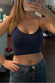 Stretchy with some support. Great alone or for layering. Haven't washed it yet. - Alexandra B.