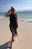 I lost my beloved black shawl on vacation two years ago and haven't found another even close until this one.  Worked great worn over the shoulders as in ad, around my waist, or even tied criss cross around my neck.  Wore it every day on vk this spring, and it held up well.  Lost a string or two, but that's not bad considering the sun, sand, and water it met. - Sarah S.