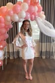 This dress was perfect for my shower! It fit like a glove and gave me great curves. The length was what I was most worried about; I have shorter legs compared to my torso and the dress came down to about mid-thigh which was perfect. I have an athletic build and the dress fit great at my shoulders as well! I got tons of compliments, was comfortable overall, and the dress didn't ride up as the day went on for me. - Courtney H.