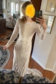 I am planning to get married in October so I thought a dress with long sleeves would be a good choice. This dress comes up high at the neck and the opening in the back is not super low, creating a very modest look and feel. The underneath is beige, but it makes the dress a pretty cream instead of stark white. It is form fitting, but stretchy so it doesn't feel tight. For the price, this dress is really great. I think the dress looks inexpensive, which is not necessarily a bad thing, but it is very soft and lightweight. I plan to dress it up even more with a pretty veil and hair piece. The only concern I have is what to do when it comes time to dance at the reception because it is a very long dress and there's nothing to pin the train up with. - Suzanna W.