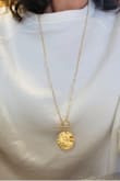 This is such a pretty necklace! Very easy to slip on and off. No strings defects either. Long and short adjustment. Bright gold shining too. I received several compliments too. I'm very satisfied and recommended 100%. - Magda M.