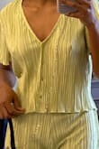 I bought this shirt along with the matching pants. The material is super nice as well as the color. It's the perfect green without being too overwhelming. It can definitely be dressed up or down. Also isn't sheer, so you can get away with not wearing a bra! I can't wait to wear it this spring! - Amani S.