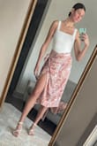 I love this wrap skirt, it is a very silky comfortable material and goes well with solid colored tops. I paired it with another Lulus item, the Symbolize White Sleeveless Bodysuit and white strappy heels from Amazon. I got multiple compliments on it and wore it out to a dinner and drinks at a nice restaurant. I'm a sucker for a good leg slit in a skirt or dress. If it's windy, just be cautious because the slit does open up to the top! I think it's the perfect combination of a sexy and classy night outfit. - Kellyn S.