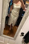 This dress looks a bit weird on the model, but decided to try it for my bridal shower. I ended up going with another dress for my shower but will be keeping this for my rehearsal dinner. I'd say this dress fits true to size/a little large in comparison to other Lulus items. In most dresses I'm a L, but here I'm wearing a M. - Lauren