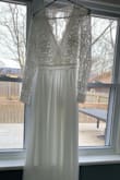 Ordered this dress for my backyard wedding in May. Feel in love with it online. Dress fit great! Was not expecting the sleeves to be so thick. Bottom is heavy as well. My back felt too exposed and I couldn't lift my arms very high. This was not the one I chose but it is really beautiful in person - Allison B.