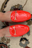 These shoes are not red. They are a very bright shade of orange that I believe could stop traffic.. at night. 
Not only is the color way off but the sizing is way off. I am a size 7.5 and because if other reviews I got this shoe in an 8.5 and it's still too small. As you can see in the picture. 
I really wanted to love these but I feel ridiculous in them. - Dana S.