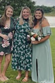 I wore this dress to a wedding in Florida in August. While most of the wedding was inside, cocktail hour was outside and I accumulated plenty of sweat in that short hour. The material is not super breathable but was lightweight and looked great all night. So even though it held on to the sweat, it never showed. I'm 5 foot 6 and this dress was definitely longer on me than it looks on the model and came almost down to my ankles (but my legs are also short for my height). Fit comfortably at the shoulders but there is no give to this material so size up if you have broader shoulders. - Ashlyn M.