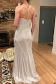 Right on the verge of me sizing down to XS, but liked that I felt very comfortable and not at all restricted in this. Gorge beading adds weight to the dress so no worries about wrinkles. I wish the back was lower cut. The smokey gray color was so pretty but might not suit all brides for a white dress look. Was long on me, would need higher heels or alterations. - Anna G.