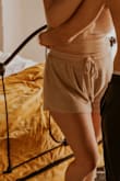 Love these shorts!! I was deciding between the medium and large and the large worked out great! They're a good length and loose but not baggy. I wore them in a cozy, at-home couples photo session and they looked great and I wear them all the time around the house. (also got the matching top) - Ivy P.