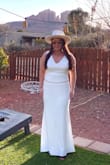 This dress was exactly as pictured! The quality of the material is great with thick material and and durable ribbon to tie in the back. I'm in between and large and a medium but ordered the large to give me some room. I also added bra cups in this dress and it really helped with the shape of the dress in my opinion. - Leslie A.