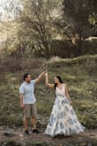 I wore this for my engagement photos and it looked stunning! A bit long for me but it was easy enough to pick up and maneuver. My bust would occasionally pop the front button open when I bent over so if you're larger be aware of that. - Noelle R.