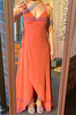 I bought this for my friend's wedding as a bridesmaids dress. I hesitate ordering online anymore because I'm kind of in between sizes (S/M). But the wrap feature makes this the perfect dress for someone like me. I ordered a S and I'm glad I did, it fits perfectly, with the exception of the length (I'm wearing 2" heels in these pictures), but that's a given for me because I'm short. Also, will probably need to pin the top to keep the ladies in...and/or wear a bra. Highly recommend! - Brittany A.