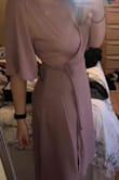 I bought this to wear to a wedding and decided not to wear it. The color was darker than I expected. The front cut runs VERY low. I am 5'7 and felt the dress is a little long to be considered midi. The chest area was very loose IMO and would have required some serious fabric tape and pinning. Felt like the string made the dress feel less "elegant". Fabric quality is great though. The dress hugs the lower half of my body nicely. Overall the dress is alright, but I did not love it. - Jennifer C.