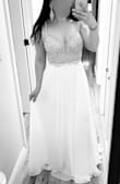 I had my eye on the True Love dress for a few years, before we were even engaged! I'm a size 6-8 in dresses normally. I ordered size 6 based on other reviews and it fits very well. It is snug around my rib cage where the bodice meets the skirt, and the skirt lining is also snug- but I would not size up or I would be swimming in it. I'm trying to lose 10-15lbs anyway. I plan to get the straps shortened so the V back doesn't hang and to get extra cups sewn in for a little more support. I also plan to have the front hemmed slightly so the back has a short train (It was a good length with 3" heels but slightly long for me at 5'3"). The beading on the bodice is very sparkly. Looks nice with a flash. Heavy and well made. All in all, very beautiful quality! Perfect to elope in. Cannot wait to wear this dress. It was True Love at first sight lol. - Kaitlin S.