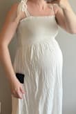 I purchased this to wear postpartum fords photos a week or so after I have my baby. It fits me at 36 weeks pregnant, so it's definitely flowy and forgiving. - Erica S.