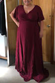 I love this dress! 
It is an option I bought for my friends wedding that I will be a bridesmaid for. Although compared to other bridesmaids dress this doesn't feel super dressy or "bridesmaid-y" per se, it is very flattering and super comfortable! 

The fabric hangs nicely and has great coverage for the bust area. 
I typically wear a size 18 jeans but decided to size up a couple sizes to a 3x (for reference) to make sure I had plenty of coverage for my bust. For the rest of the dress, definitely could have gone a couple sizes down and it would have fit perfectly fine. 
It worked perfectly and I can just tie the waist tighter to fit my mid area. 

This is perfect for a dressy night out or to wear as a guest to a wedding! I think I'm going to need something to spice it up in terms of a bridesmaid dress but it is super flattering and works for a full bust which is HUGE for a wrap dress! 

Also ordered in the short version in the same size just to have on hand, and love that one too! - Emily R.