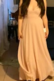 This dress is absolutely perfect for my best friend's wedding. It's simple, but elegant and sexy without pulling focus from the bride! It's truly soft pink (PANTONE  12-1209 TPX) the exact color. It runs true to size and fits like a glove! I did have the dress hemmed to fit with 4 inch heels and it floats beautifully with every step. The boning in the front is not obvious and really helps everything up top look  great. This will be a backless bra dress and seamless underwear are a must! I wore nude ones for the photo to demonstrate how sheer it is. The back is beautiful and the button detailing hides the easy to access zipper. I absolutely love this dress and you will too! - Valerie D.