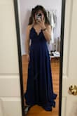 I always look at reviews before I get a dress so I wanted to write one in case your in the same position as me! The model photo makes the dress look kinda greyish blue but the dress in person is a dark blue. It's really pretty and fit me perfectly! It's super flowy and covers your bust area nicely. It also has adjustable straps which really helped. The only thing is that it's really long, I'm 5'3" and even wearing heels only helps a little. overall, I really recommend this dress! - Mary L.